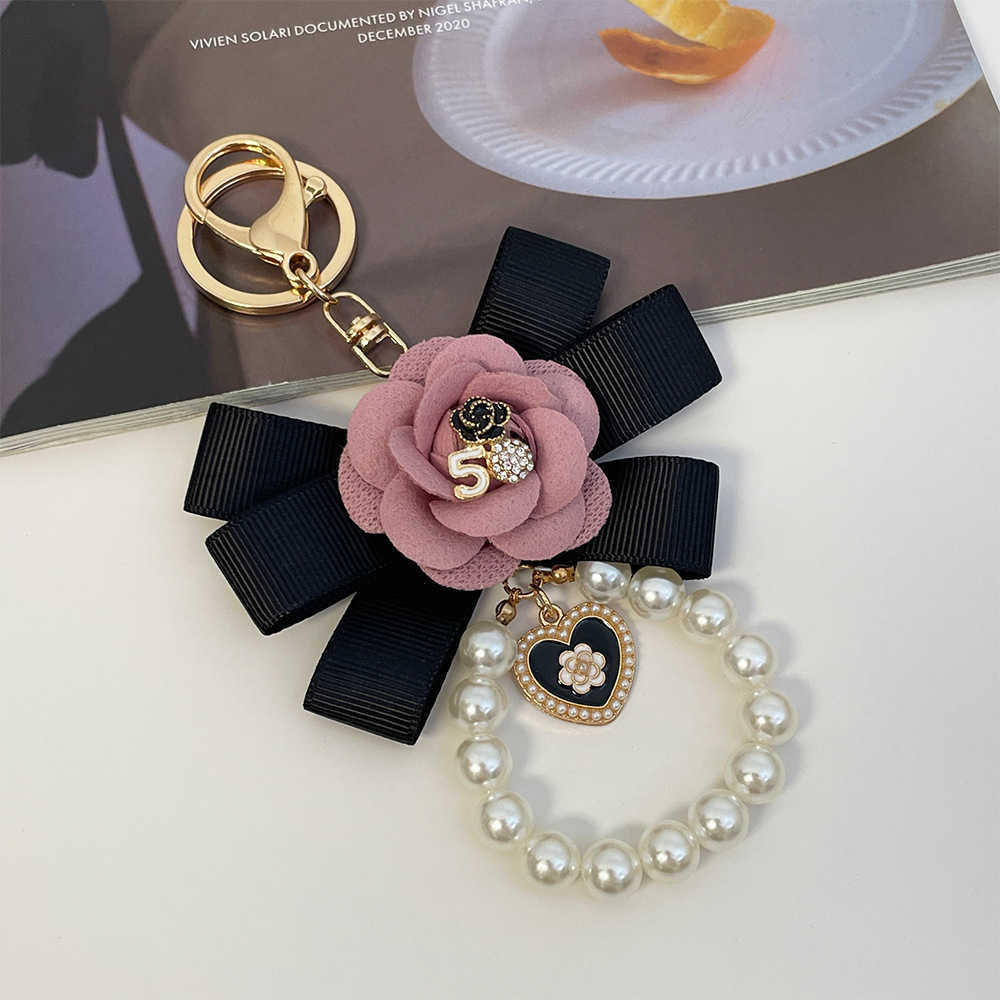 Highend Exquisite Korean Fashion Creative Camellia Ribbon Pearl Keychain Womens Bag Pendant Small Gift J251118