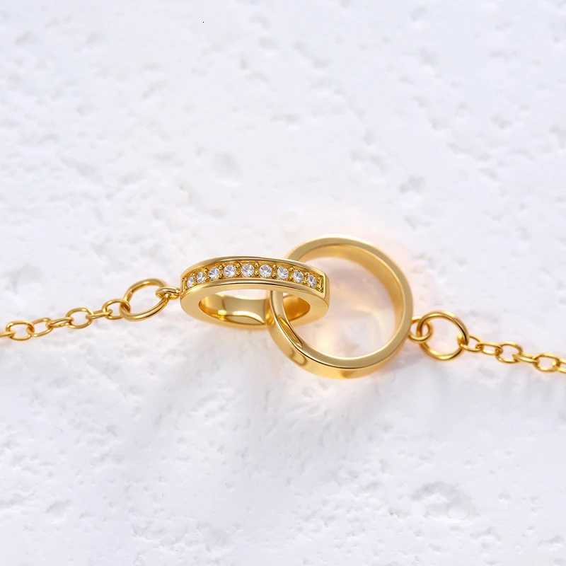 A necklace with two round rings connected by a clasp and set with zirconia stones engraved with the word loveXJ251030