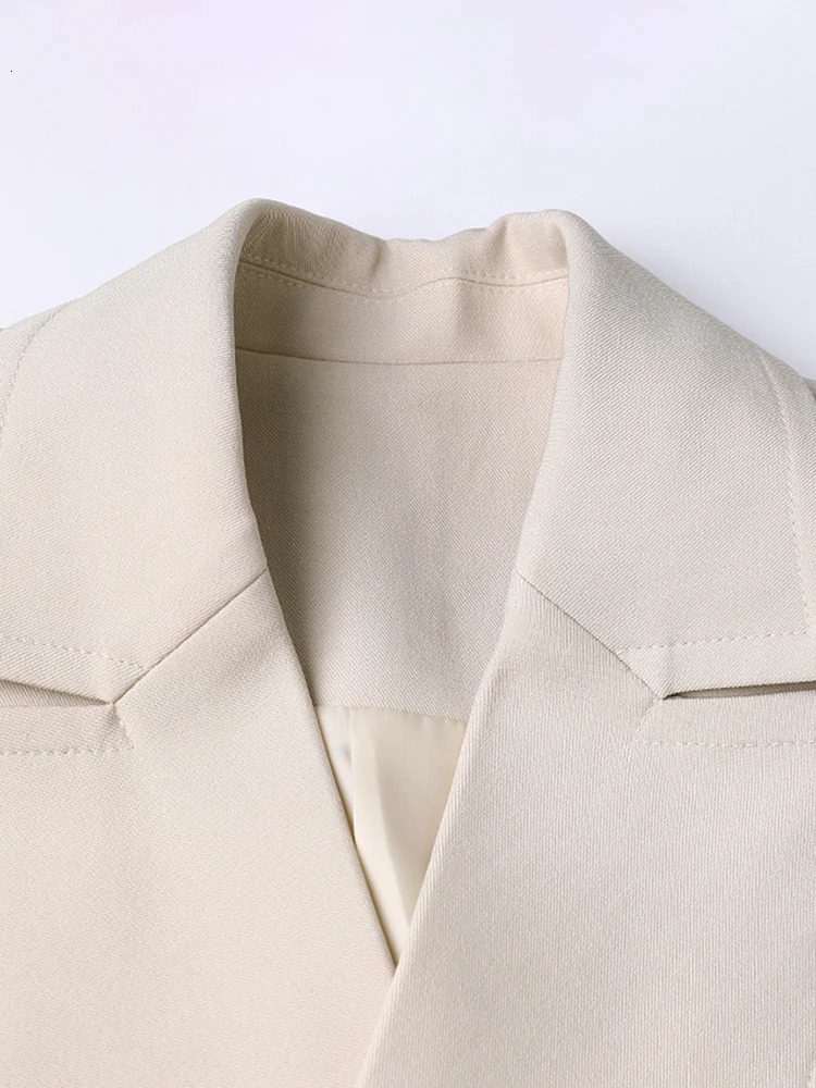 TWOTWINSTYLE Solid Spliced Pockets Irregular Trench For Women Lapel Long Sleeve Tunic Patchwork Button Temperament Coats Female 251029