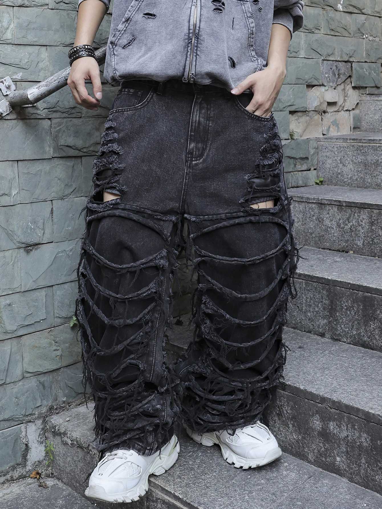 Mens black jeans With a design of ripped holes and tassels In a street trend style J2510301