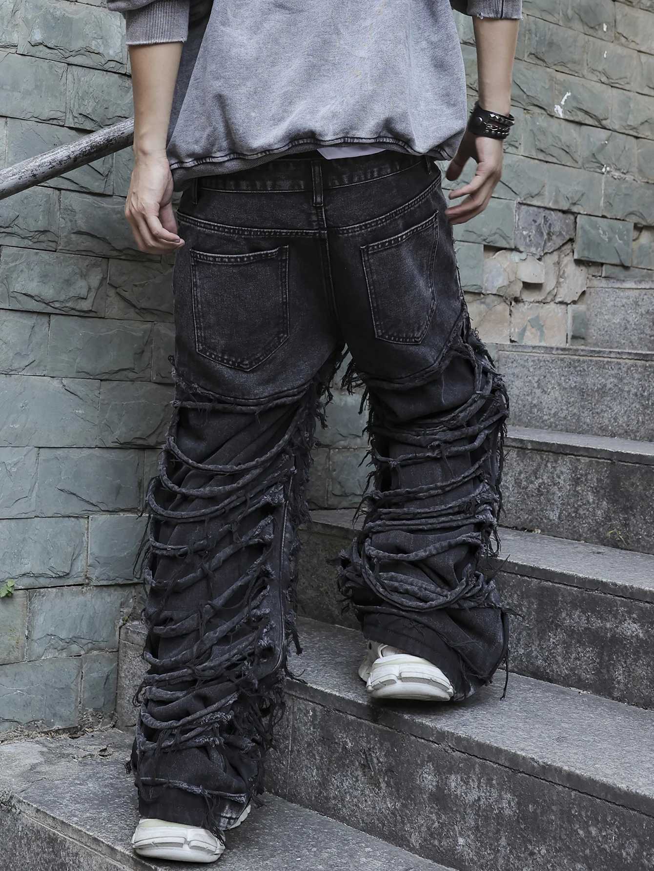 Mens black jeans With a design of ripped holes and tassels In a street trend style J2510301