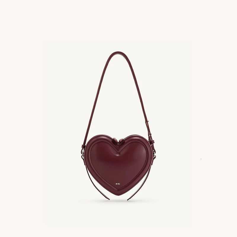 Womens commuter heartshaped crossbody bag niche design threedimensional heart genuine leather singleshoulder crossbody bagW251031