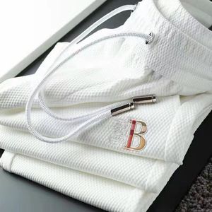 Printemps et automne de luxe léger pantalons de sport brodés européens minces et haut de gamme pour les pieds lâches des hommes