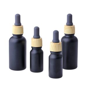 Botella de perfume de aceite esencial e líquido de vidrio negro mate con gotero de pipeta de reactivo y tapa de grano de madera 10 / 30ml