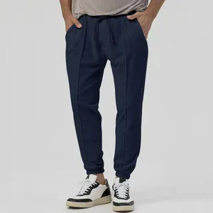 Pantalon pour homme 2023 avec cordon de serrage à la taille, couleur pure, mode polyvalent, décontracté avec jambes fuselées, grande quantité et excellent prix.