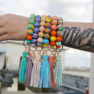 LLavero de silicona de colores mezclados, borla de cuero, cuentas de madera, pulsera, llavero para llaves, llavero de moda para hombres y mujeres, venta al por mayor, 2022 nuevo