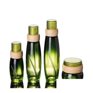 Bouteilles d'emballage En gros 50 pièces/lot 40 ml 100 ml 120 ml bouteille en verre vert avec pompe à presse forme en bois couvercle Lotion pour cosmétique Sn2669 Dhuru