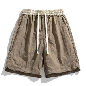 Ueteey shorts d'été hommes tendance décontractée de style coréen marque à craqs de couleur solide coulant courant extérieur pantalon court mâle 240411