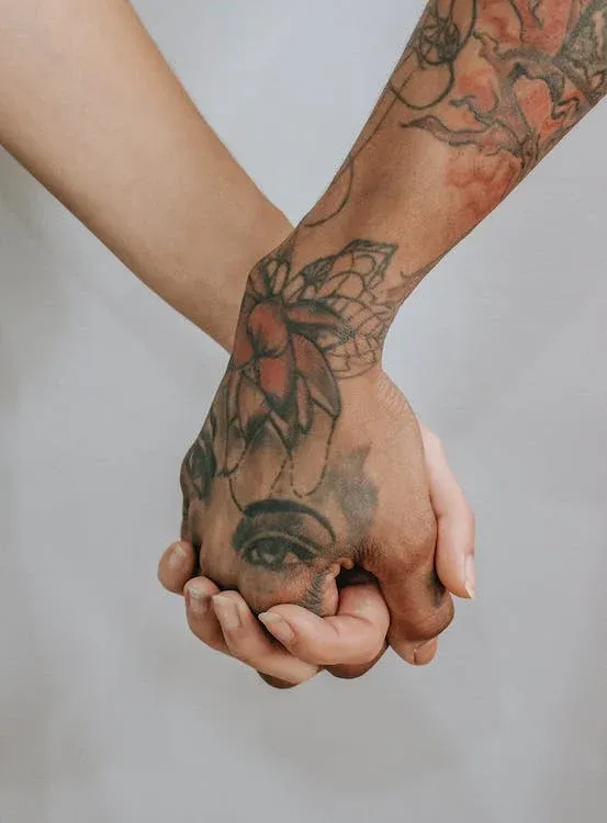 10 Holding Hands Tattoo Designs to Show Your Love and Connection