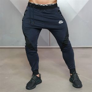 Al por mayor-Pantalones para hombres Ropa de entrenamiento Pantalones deportivos de algodón activos Hombres Pantalones de basculador Pantalones de chándal Legging inferior