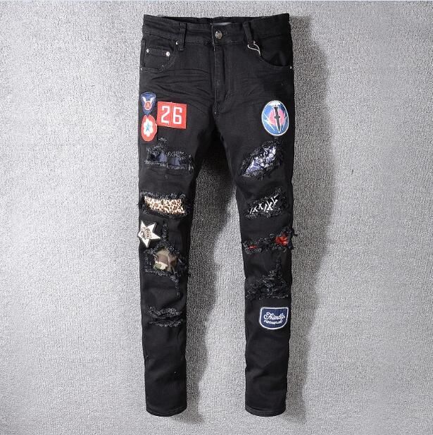 black amiri jeans with patches
