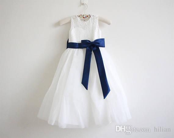 white flower girl dress with navy sash