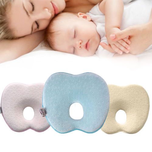 baby sleeping on pillow in cot