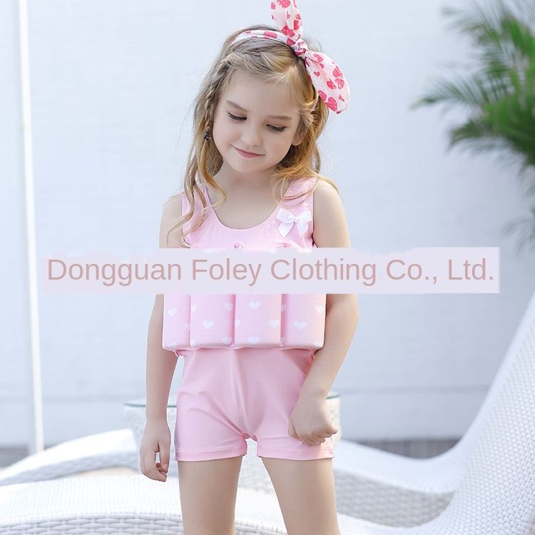 boy in girl's one piece swimsuit