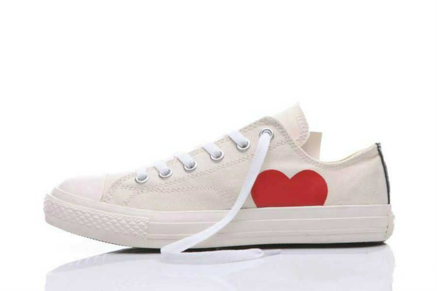 white sneakers with red heart and eyes