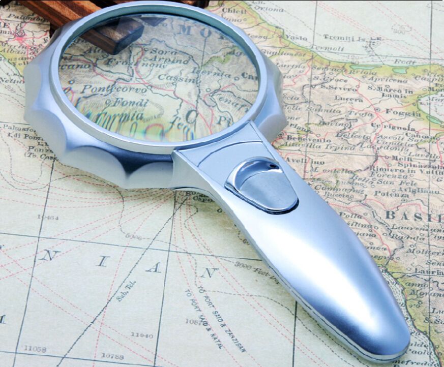 map reading magnifying glass with light