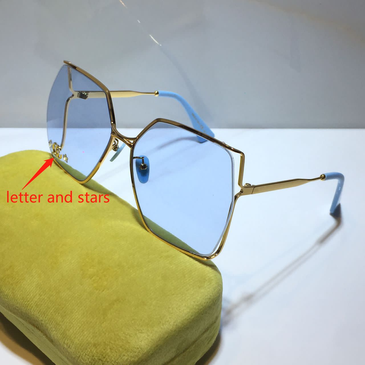 gold light blue lens with letter stars