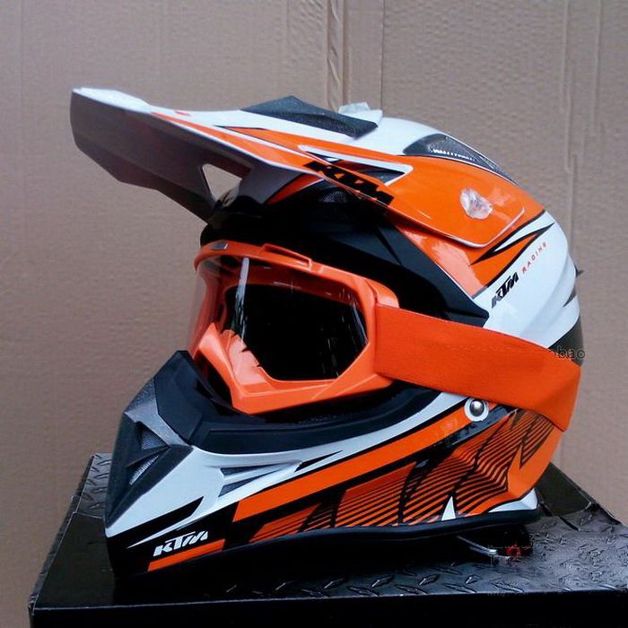 black and orange motocross helmet
