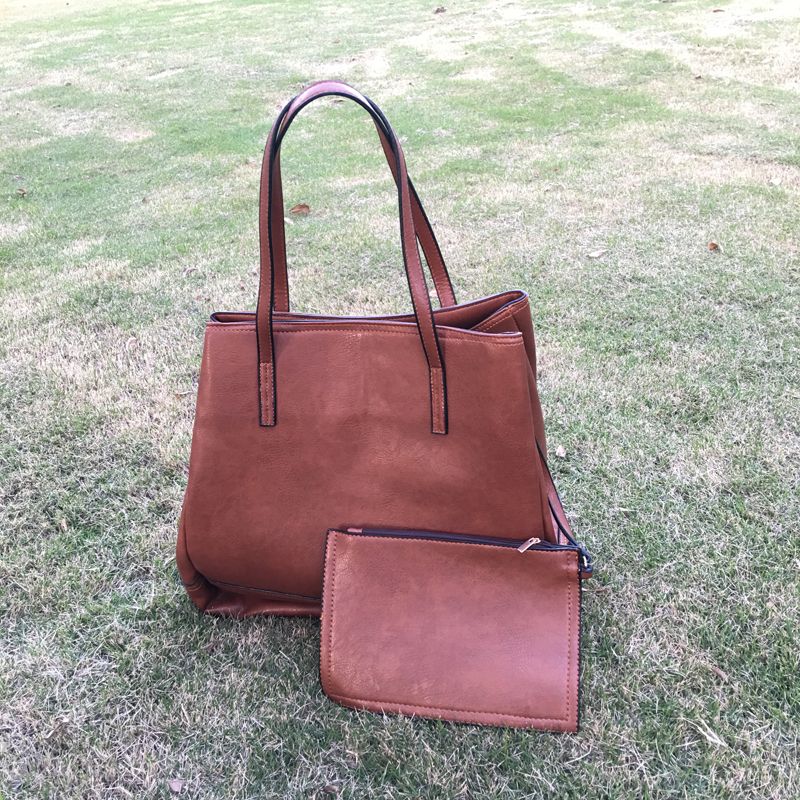 black leather tote bag with red inside