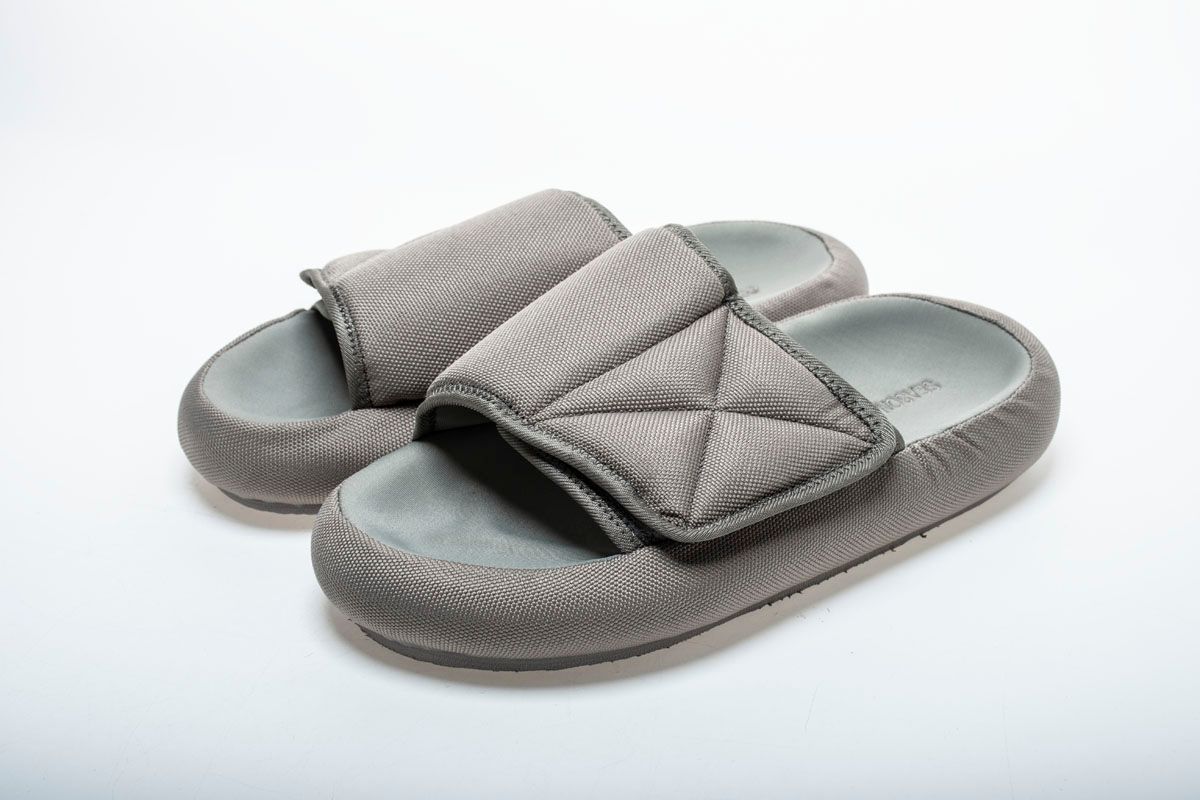 Kanye West ridiculed for wearing tiny Yeezy slides and socks.
