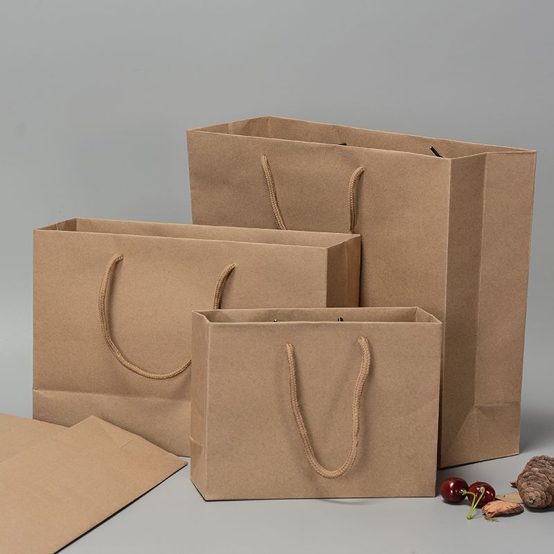 Versión horizontal Bolsas pequeñas de papel Kraft Bolsas de embalaje Con asas de