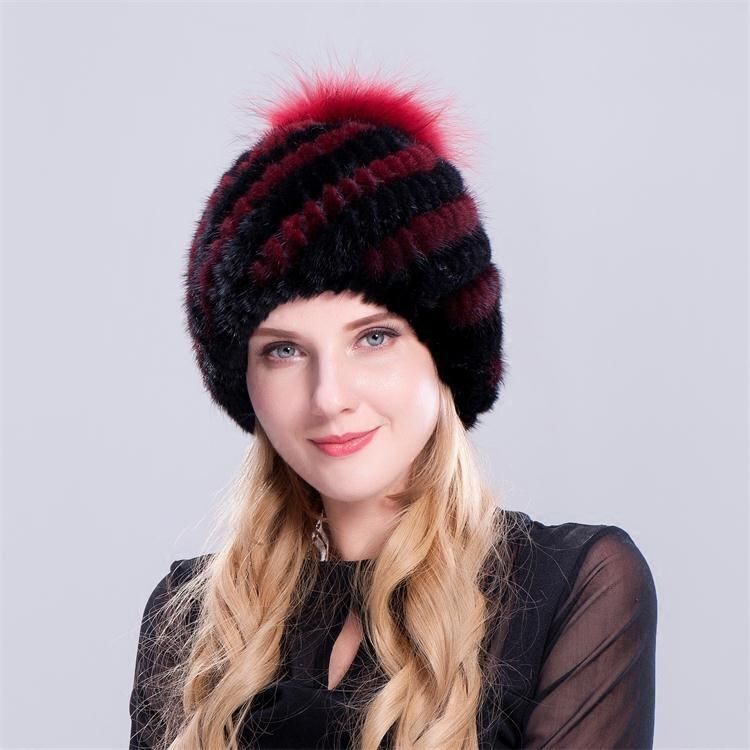 black leather hat with fur ball on top