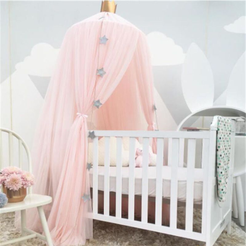 white and pink crib