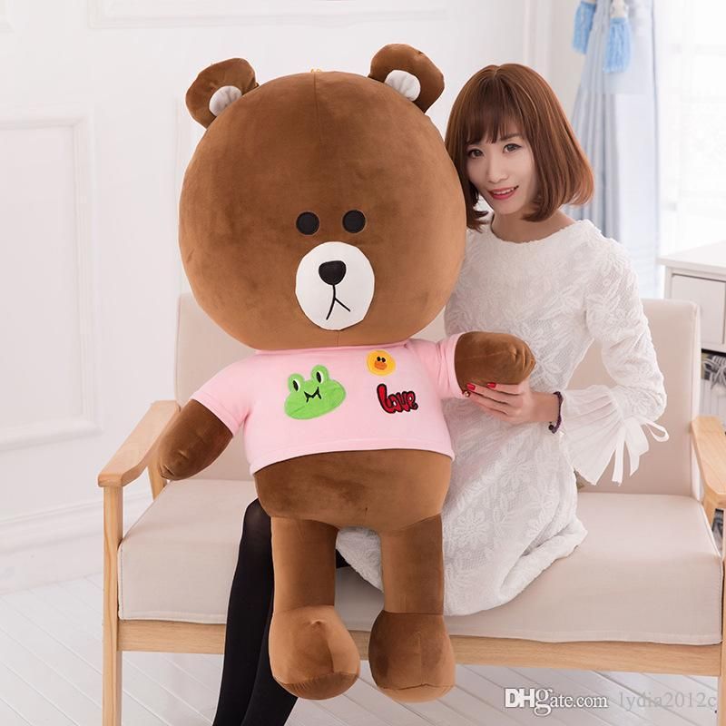 girl hugging huge teddy bear