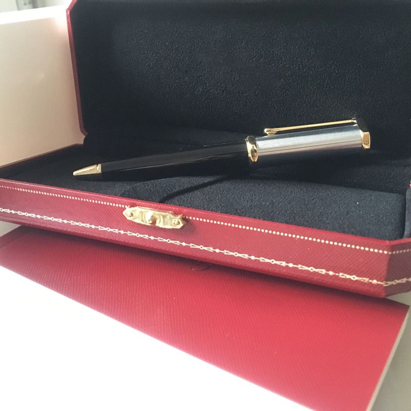 ein schwarzer goldener Stift und eine Box