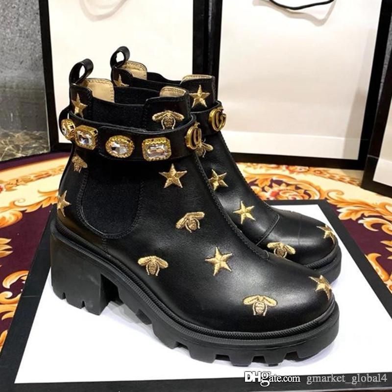 embroidered leather ankle boot with belt gucci