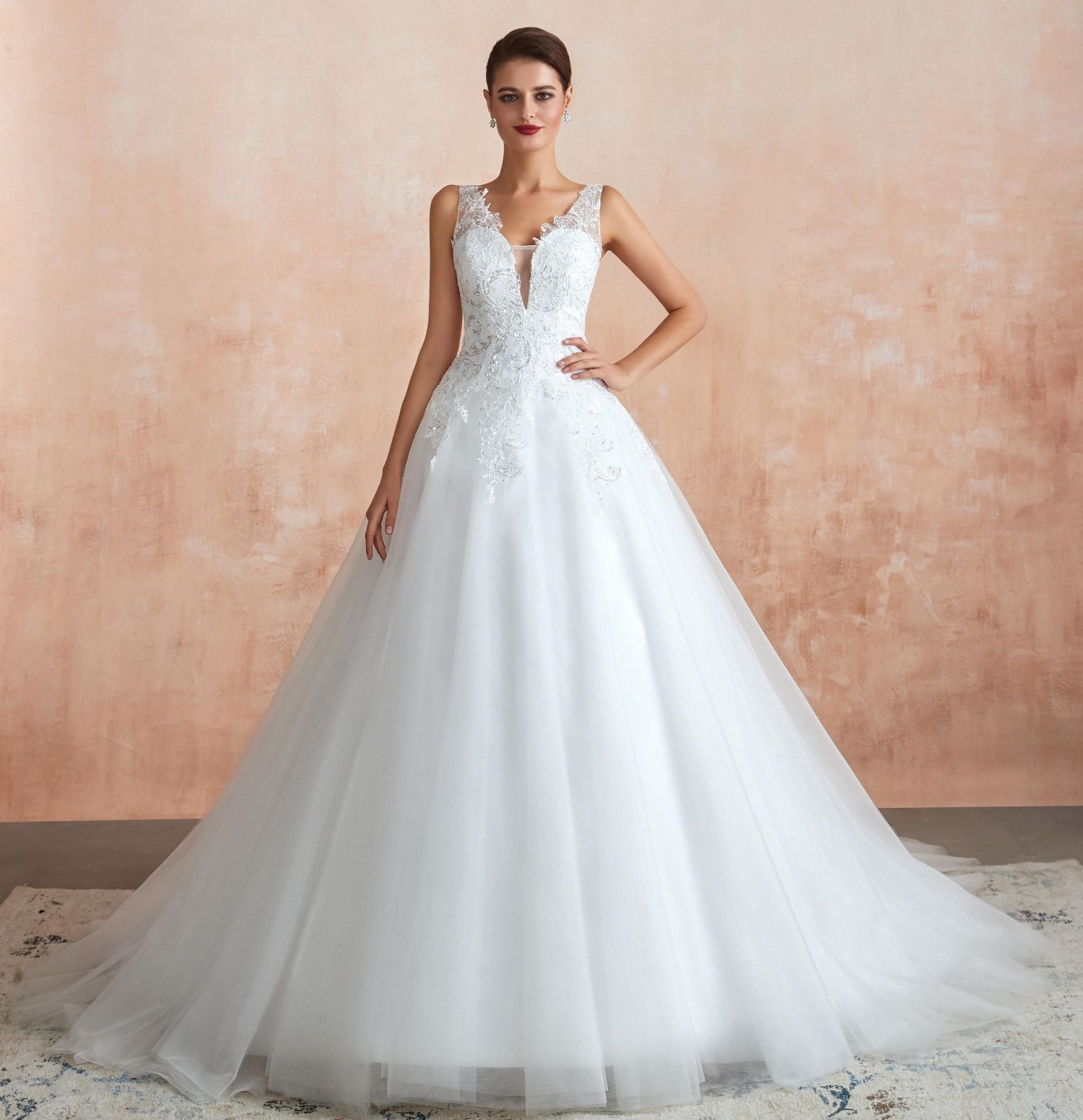 A romantic A-line wedding dress with a sheer bodice, long 