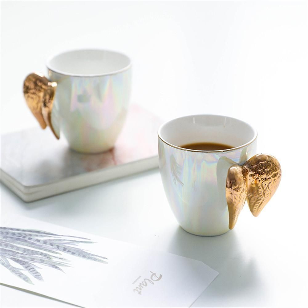 A Creative White Ceramic Mug Gold Plated Handle Angel Wings Office