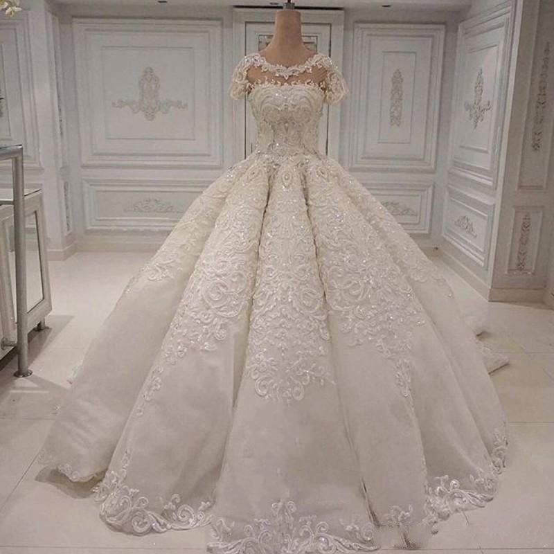 Compra Imágenes Reales Vestidos De Novia Elegante Largo Dubai Arabia Vestido  De Bola Apliques De Encaje Granos De Cristal Mangas Cortas Vestidos De Novia  Barato | Entrega Rápida Y Calidad | Es.Dhgate