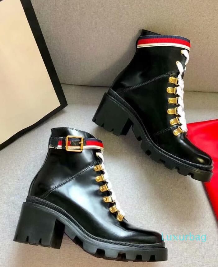 black combat boots with gold buckles