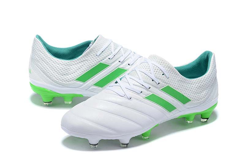 green and white football boots