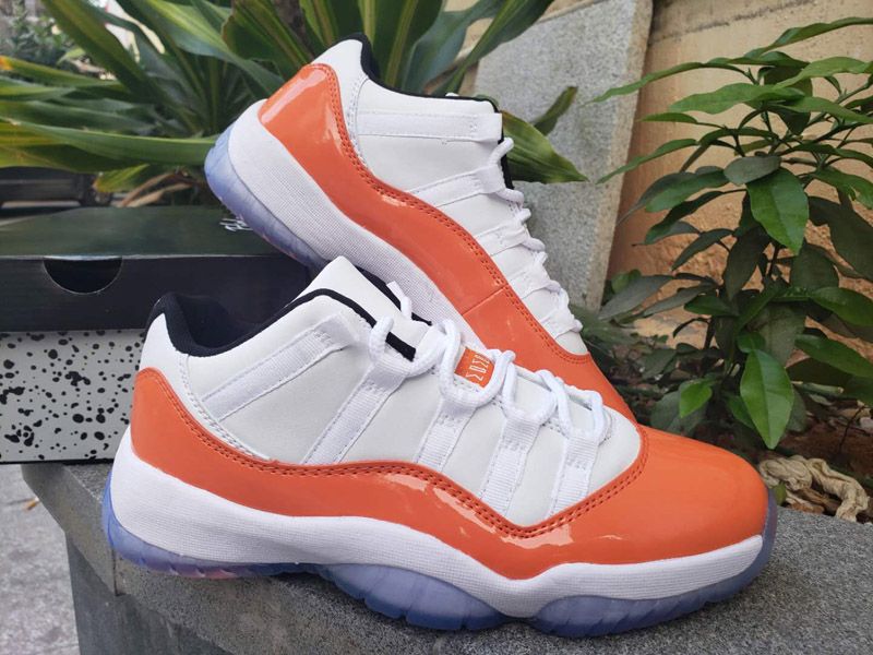 orange and white low top 11s