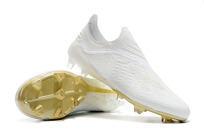 gold laceless football boots