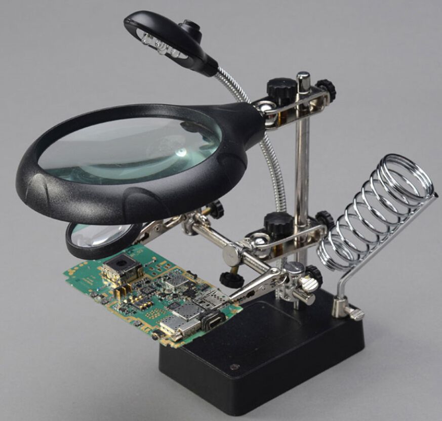 A Multiple Of A Magnifying Glass With A Circuit Board Soldering