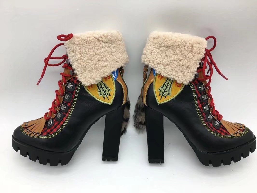 black boots with yellow stitching