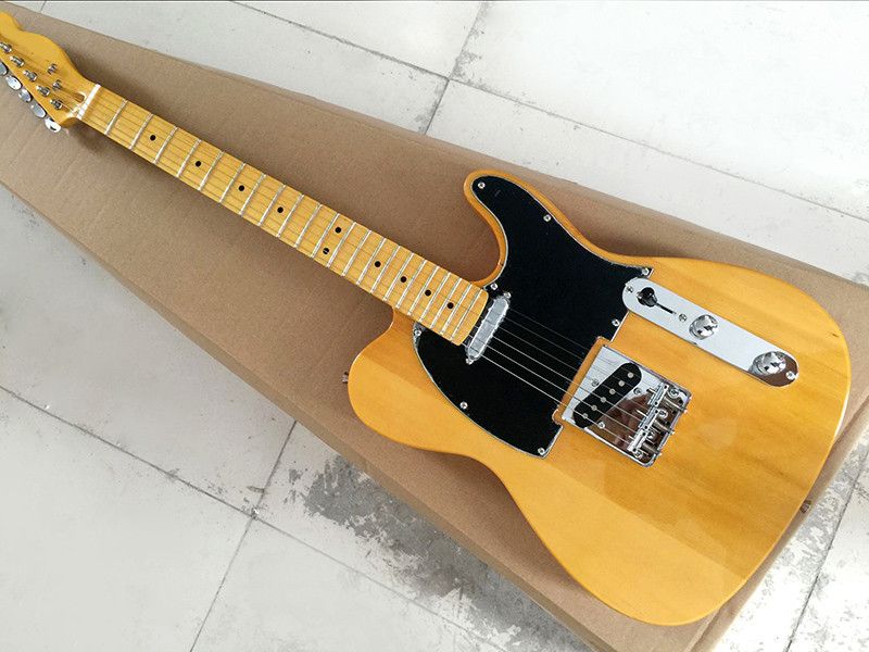 The Light Yellow Electric Guitar Is Equipped With Black Guard Board
