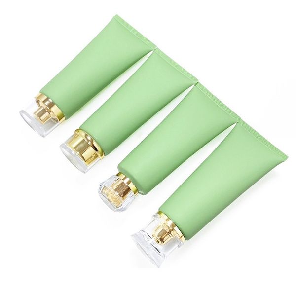 Bouteille en plastique cosmétique de tuyau de compression givré vert 100g Tubes d'extrusion de nettoyant pour le visage de voyage rechargeables avec bouchon en or / pompe sans air