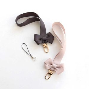 1 UNID Correas de teléfono celular Charms Bowknot Cadena móvil Colgante Correa de mano universal Regalo para niños Amigos Insignia USB Cordón de muñeca Nueva venta al por mayor Y2211