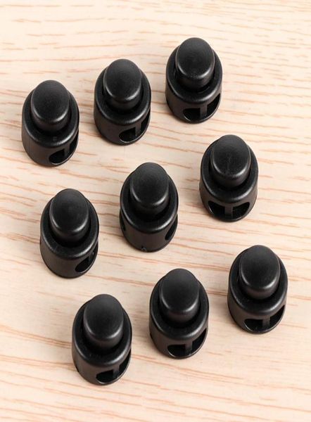 200pcs 2 hoyos negros de 11x17 mm de bloqueo de cable de cable botón Terrón de alternancia Capacal Butter Spring Buckle Shoelace Mochila Bolsa Accesorios3972129