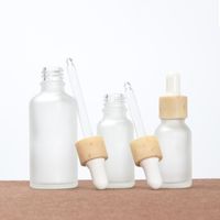 Botellas de gotero de vidrio esmerilado Botellas de aceite esenciales con tapas de bambú imitadas Recipientes de cosméticos líquidos esenciales recargables