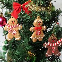 12pcs // Lot Gingerbread Man الحلي لشجرة الكريسماس التماثيل الزنجبيل التجزئة قلادة لزخارف عيد الميلاد المعلقة 0812
