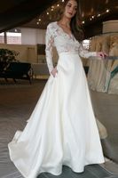 Vestido de novia largo barato con la ilusión de manga larga de encaje ver a través de falda de la tapa con los bolsillos línea diseñador Un vestido de novia vestidos de boda