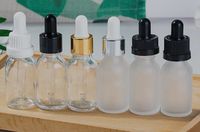 Wholesale 15ml glass dropper bottle vape e liquid perfume essential oil bottle clear frosted amber blue green with gold silver white cap china