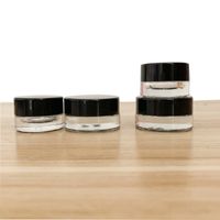 Wholesale bag Glass Jar Cream Containers ml ml Dab Wax Thick Oil Black cap Clear Tank Portable Cosmetic box Jars Packing for Sample Container