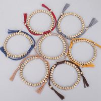 Wholesale Creative Hand woven Tibetan Copper Bead Turning Cylinder Bracelet Buddhist Woven Cotton Thread Lucky Knot Bracelet