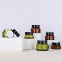 Wholesale Oblique Shoulder g g g Amber Green Glass Cream Empty Jar Bottle with Black Lids For Make Up Sample
